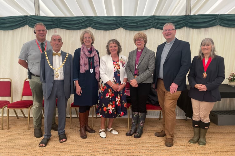 The Show President, centre, Mrs Rosemary Chanin, with, from left, Chairman Angus Cottey, Cllr Frank Letch, the chairman of Mid Devon District Council; Rt Rev Jackie Searle, the Bishop of Crediton, and from fifth left, Dame Sarah Mullally, the Bishop of London; The Archdeacon of Exeter, Rev Andrew Beane and right, the Mayor of Crediton, Cllr Elizabeth Brookes-Hocking. AQ 3007