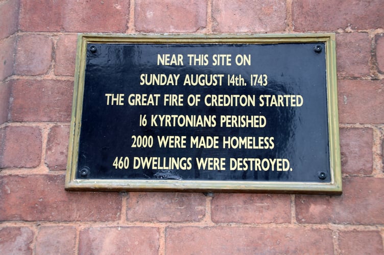 The sign in Crediton High Street which marks details of the Great Fire of Crediton. AQ 5216