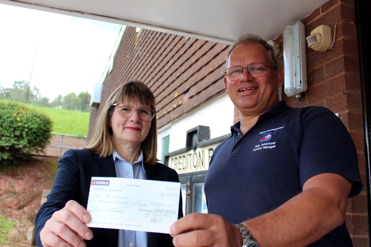 Liz Goodman presenting the £535 cheque to Rob Johnstone, DAA Safety Manager. SR 8836