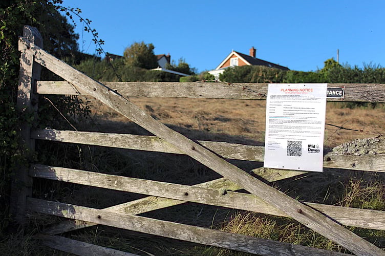 The planning notice on the gate to the field for which planning permission is being sought.  SR 8854