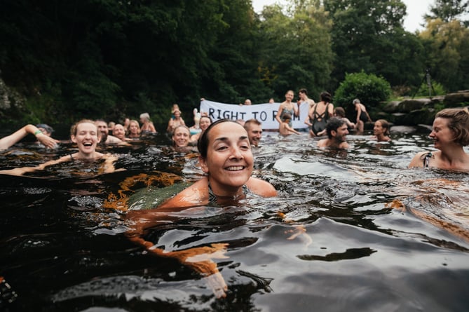 Right to Roam protest swim on Dartmoor. Wild swimmers at Spitchwick in defiance of a notice by the landowners to stop people swimming at the beauty spot. Jackie Lake in foreground.
