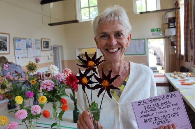 Sally Rowden holds her dahlias that were best in the flower section.  SR 8838