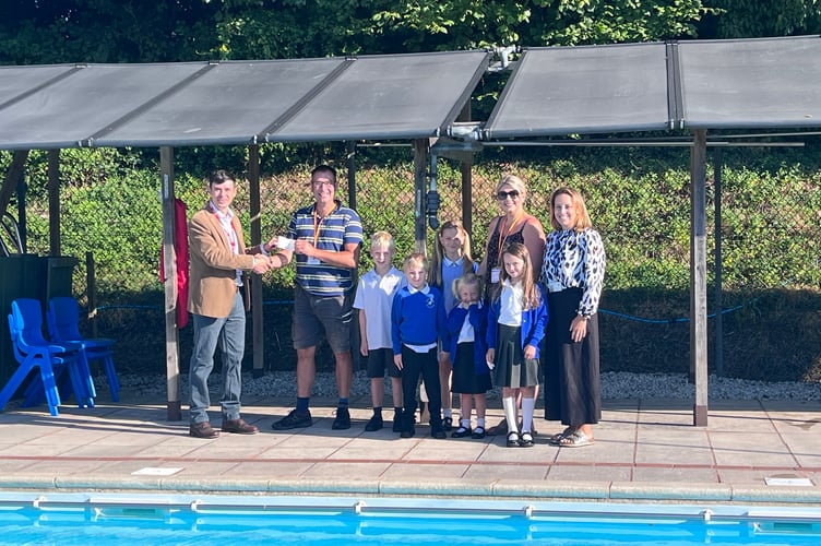 The presentation being made by Crediton Freemason Lee Fallows, left, to Rob Bishop, Bow Swimming Pool Committee Chair person.