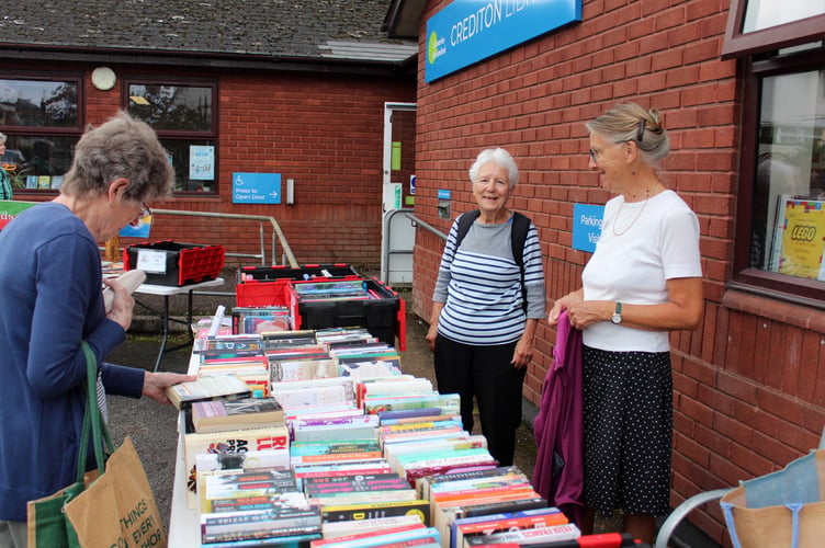 A customer browses the books at the Friends of Crediton Library book sale. SR 8818