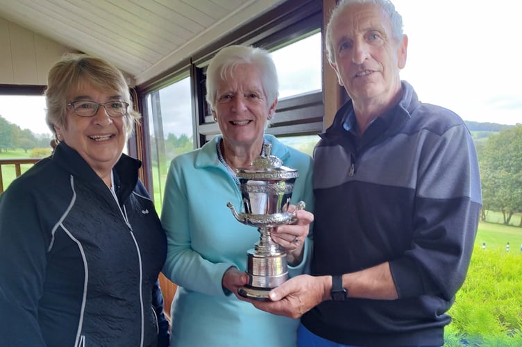 Okehampton Lady Captain Di Johnson, left, with the Dora Milner trophy winners Penny Deakin and David Stanbury.