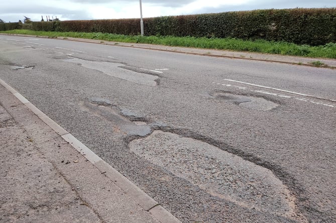 The poor state of the A377 road near Copplestone Farm Shop.