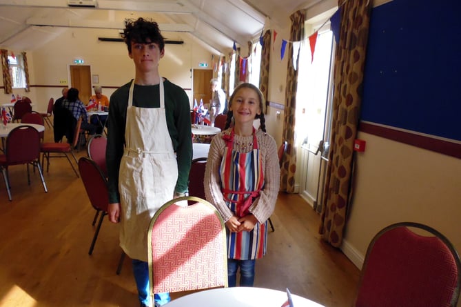 Zephyr Cawthorne (14) and sister Flora, aged 10, helping with the food at the Twinning event.