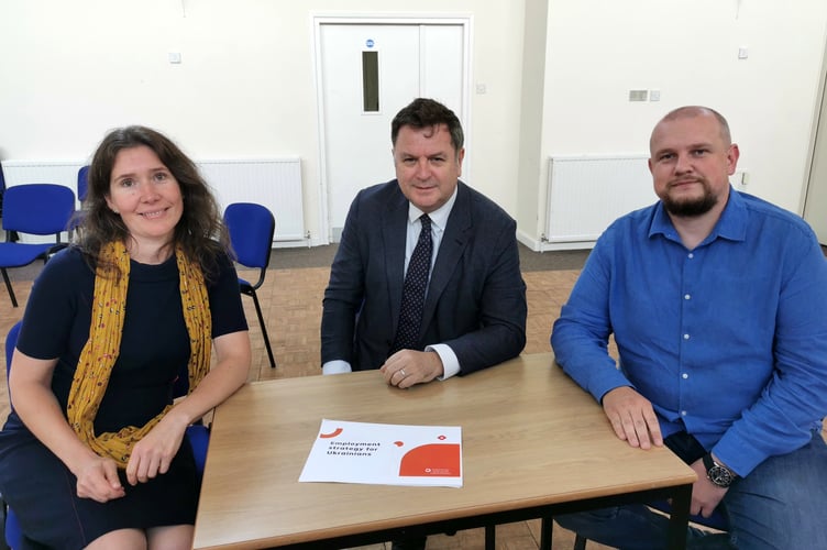 Silverton Ukrainian resident Tanya Larsen and Ukrainian refugee Eugene Soloviov discussing help for refugees in accessing local job opportunities.