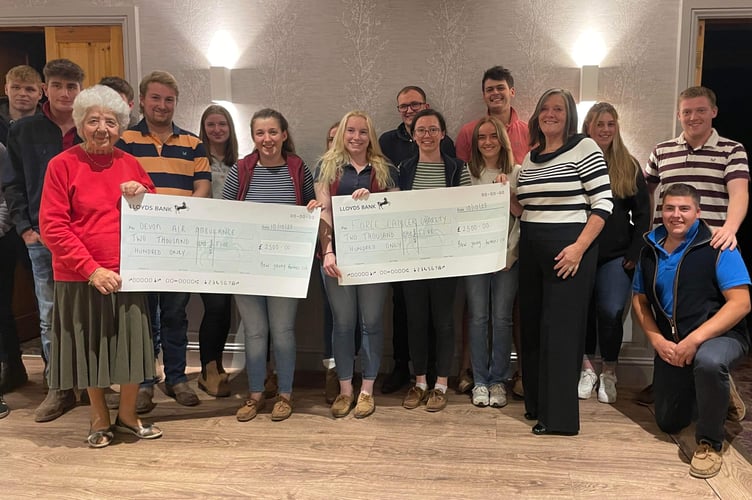 The charity representatives from FORCE and Devon Air Ambulance receiving the bumper cheques from Bow YFC members.