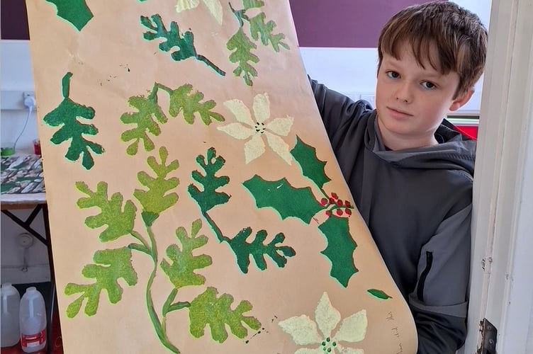 Ethan with his Christmas wrapping paper.