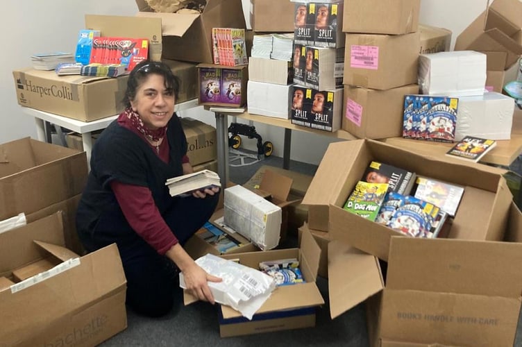 Dee with books going to Crediton Foodbank.