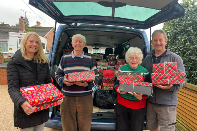 From left, Jan Holland, Derek Shapland, Margaret Tucker and Biffo Holland, with some of the shoeboxes which left Crediton this week.  AQ 9236