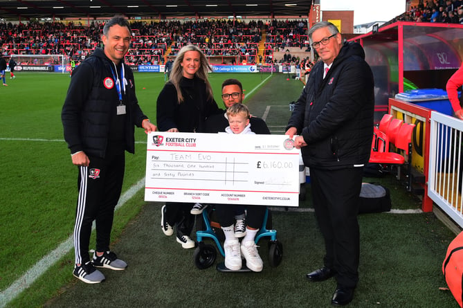 Left to right, Scott Walker, Exeter City Community Trust, Jess and Pete Eveleigh with their son, and Clive Harrison of Exeter City FC at the recent presentation of the money raised.