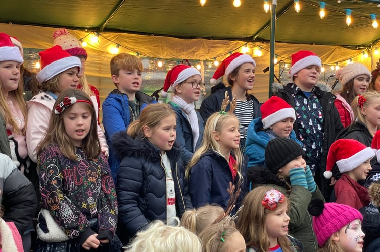 Children singing in the Town Square last year. AQ 9520