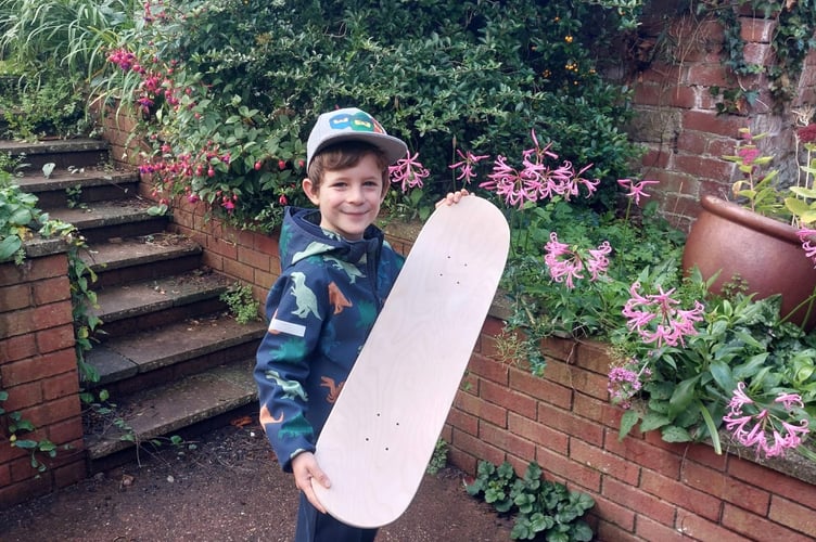 Miles picking up the skate deck he won.