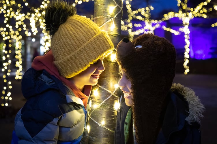 Children enjoy exploring the lit landscape at RHS light installation.