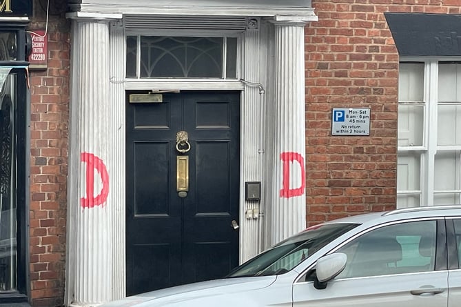 Graffiti on pillars at a private address in Crediton High Street.  AQ 0575
