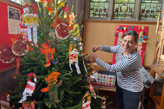 Decorating a tree at last year’s Christmas Tree Festival in Crediton Parish Church.
