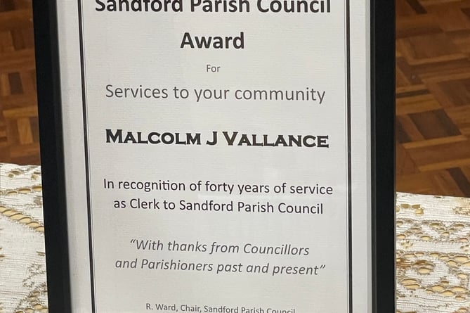 A framed certificate to acknowledge Malcolm Vallance’s 40 years as Sandford Parish Clerk.  AQ 1035
