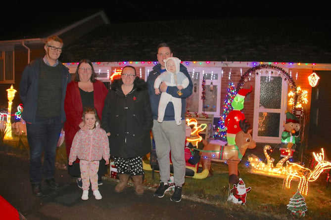 Alan Northcote, his wife Jill and family with a part of the display of lights at 41 Meadowside Road, Sandford.  AQ 3100
