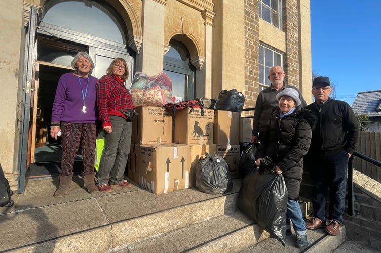 Chris Freeman and Abi Hindriks, left, with other volunteers with some of the boxes of clothes ready to be loaded to go to Refugee Aid. AQ 1242