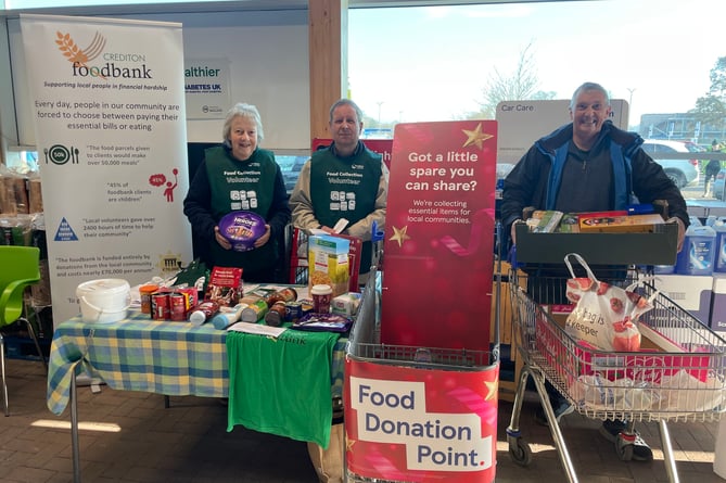 Richard and Renate Johnson, volunteers at the Crediton Foodbank collection point at the Crediton Tesco superstore with Cllr Guy Cochran, right, ready to take another full box to the Foodbank.  AQ 1248
