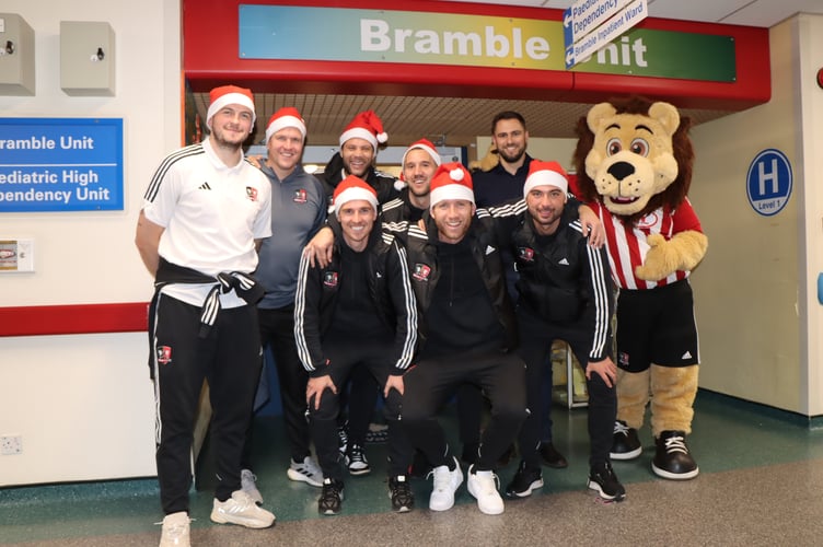 Exeter City FC players delivering presents to children in the Bramble Ward at the Royal Devon and Exeter Hospital.