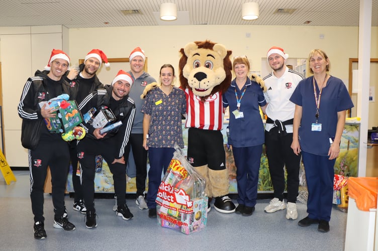 Exeter City FC players delivering presents to children in the Bramble Ward at the Royal Devon and Exeter Hospital.