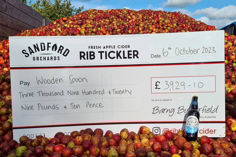 The cheque from Sandford Orchards to the Wooden Spoon Charity.