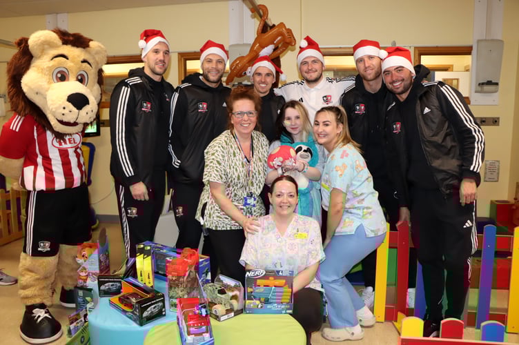 Exeter City FC players delivering presents to children in the Bramble Ward at the Royal Devon and Exeter Hospital.