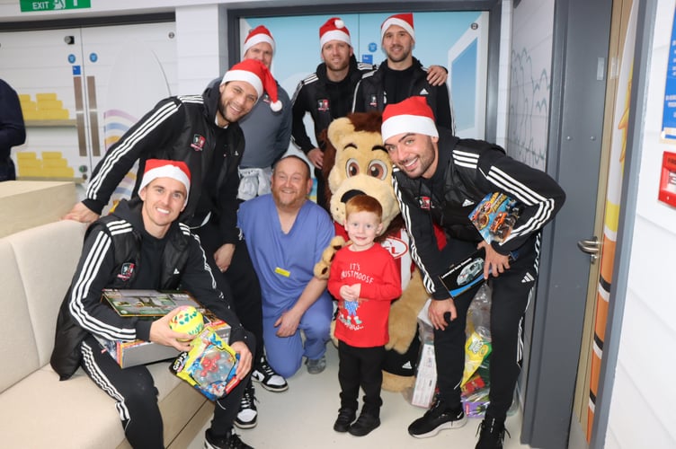 Exeter City FC players delivering presents to children in the Bramble Ward at the Royal Devon and Exeter Hospital.