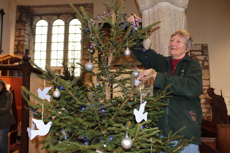 Vicky Rose decorating the Memory Tree on which visitors can hang names of people they wish to remember. SR 9263