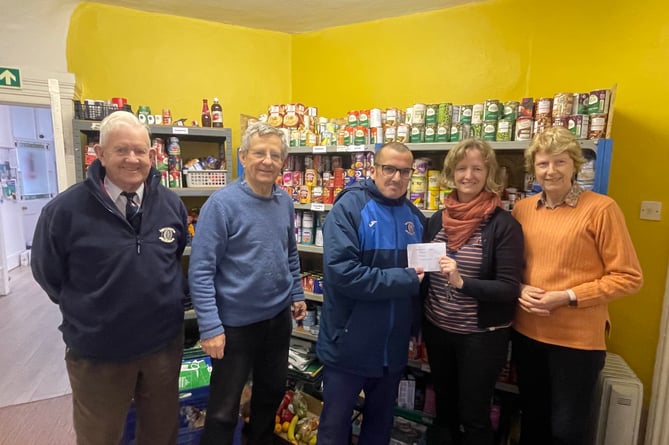 Ian Cann, third left, presenting the £120 from Crediton Football Club to Fiona Cochran, from Crediton Foodbank, with left, Dave Blanchford (Crediton Football Club), with second left, Peter Bunn and right, Debs Bunn, volunteers at the foodbank.  AQ 1381
