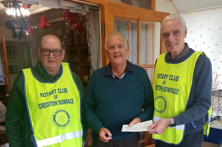 Lucky winner Jim Wills, centre, receiving a cheque from Rotary President Garry Adams.  Left is Rotarian Mike Davis who sold Jim the lucky winning ticket.