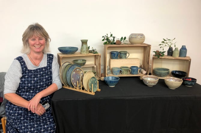 Gill Lomas with some of her pottery.
