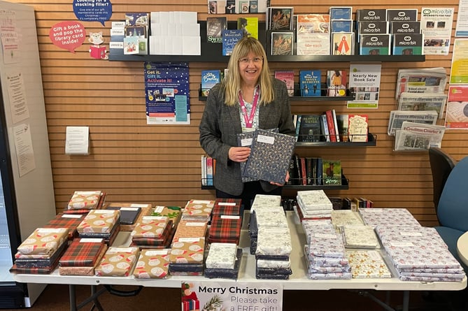Crediton Library Supervisor Sue Lee behind the Christmas gift book table in Crediton Library.  AQ 2212
