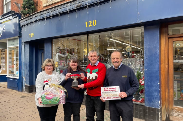The Best Dressed Shop Window in Crediton this Christmas in the Crediton Courier competition was Adams Home Hardware. The Crediton Rosebowl was presented by Alan Quick, Editor of the Crediton Courier, third left, with Crediton Morrisons community champion Hazel Evely, left, with the prizewinning hamper.  AQ 2443