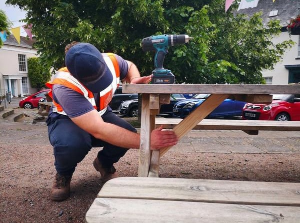 One of The Turning Tides Project team carrying out maintenance on one of the benches in the Town Square.
