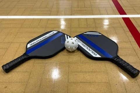 The pickleball ball and bats.