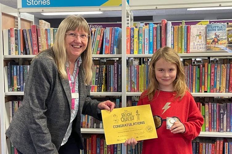 Leah Reis from Crediton received a certificate and badge for reading 100 books borrowed from Crediton Library. AQ 4605