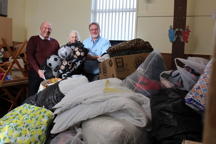 Holding a big bag of footballs between them are Ken Harris and Ian and Jayne Finch.  SR 9462