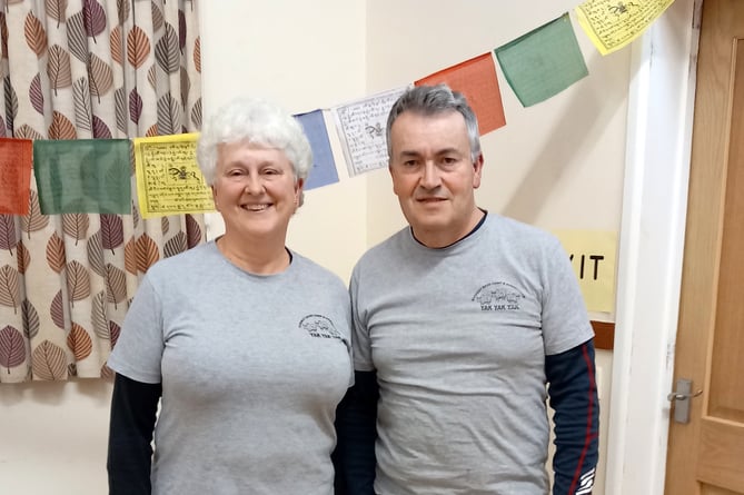 Pictured are Wendy and David in front of prayer flags.