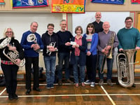 Crediton Town Band present cheque to Crediton Foodbank
