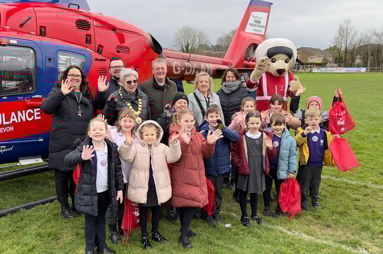 Left to right, Fremington Parish Council Projects Manager Jude Wood, Cllr Sue Kingdom, Cllr Rhys Jones, Cllr Frank Biederman, Cllr Joy Cann, Maddy Goodyear, Administration Assistant and Cllr Helen Walker with students from Roundswell Community Primary Academy and DAA Mascot, Ambrose!