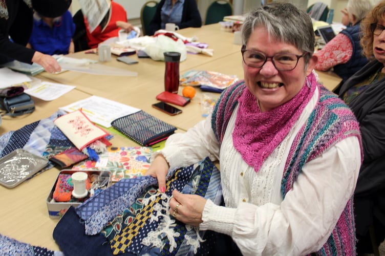 Laura Horner with a bag she is making using old ties. SR 9456