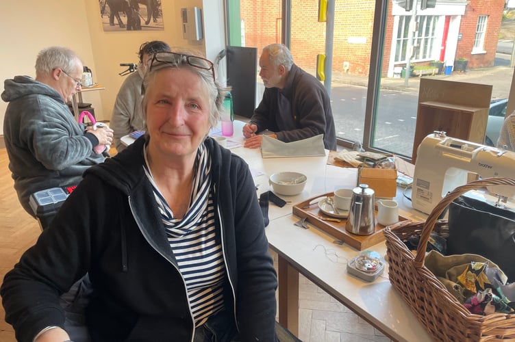 Caroline Ward spent her time sewing items that needed repair last month. AQ 4457