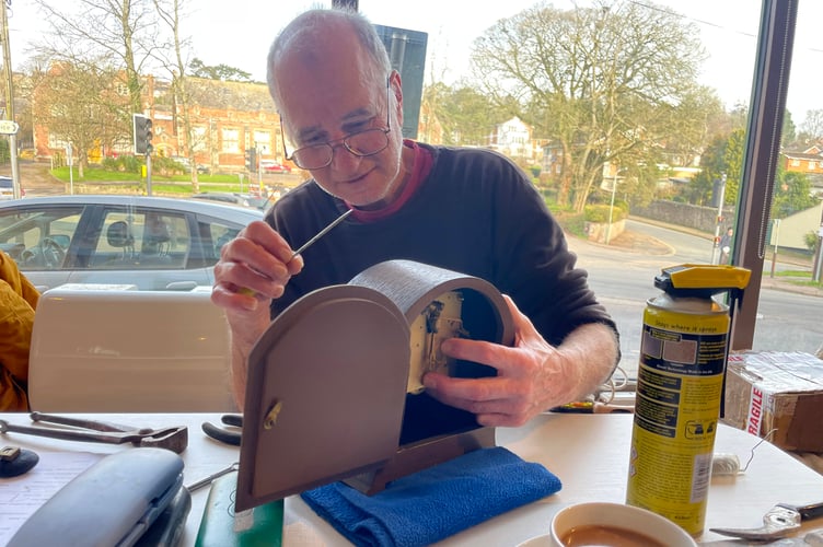 Repairing a clock at Crediton Repair Cafe last month. AQ 4443