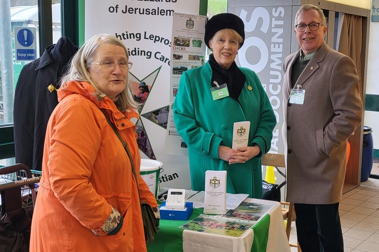 Philip Hutchens and his wife and a shopper making a donation during the collection at Crediton Morrisons.