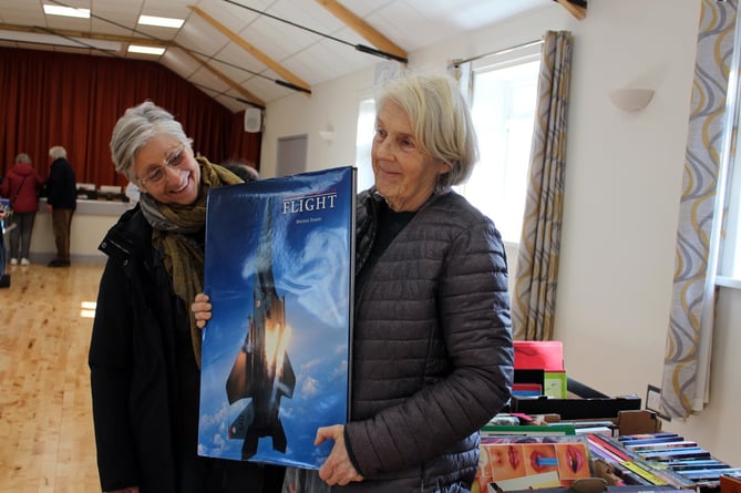 Book Fair organiser Persis Bower holding the biggest book in the room with Jan Mitchell who was secretary of the Spalding Hall for many years until recently.   SR 9472
