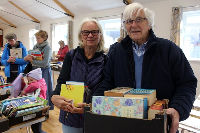 Malcolm Davies and Christine Thomas with books to help stock the new library in Hittisleigh Village Hall for which shelving is needed.  SR 9470
